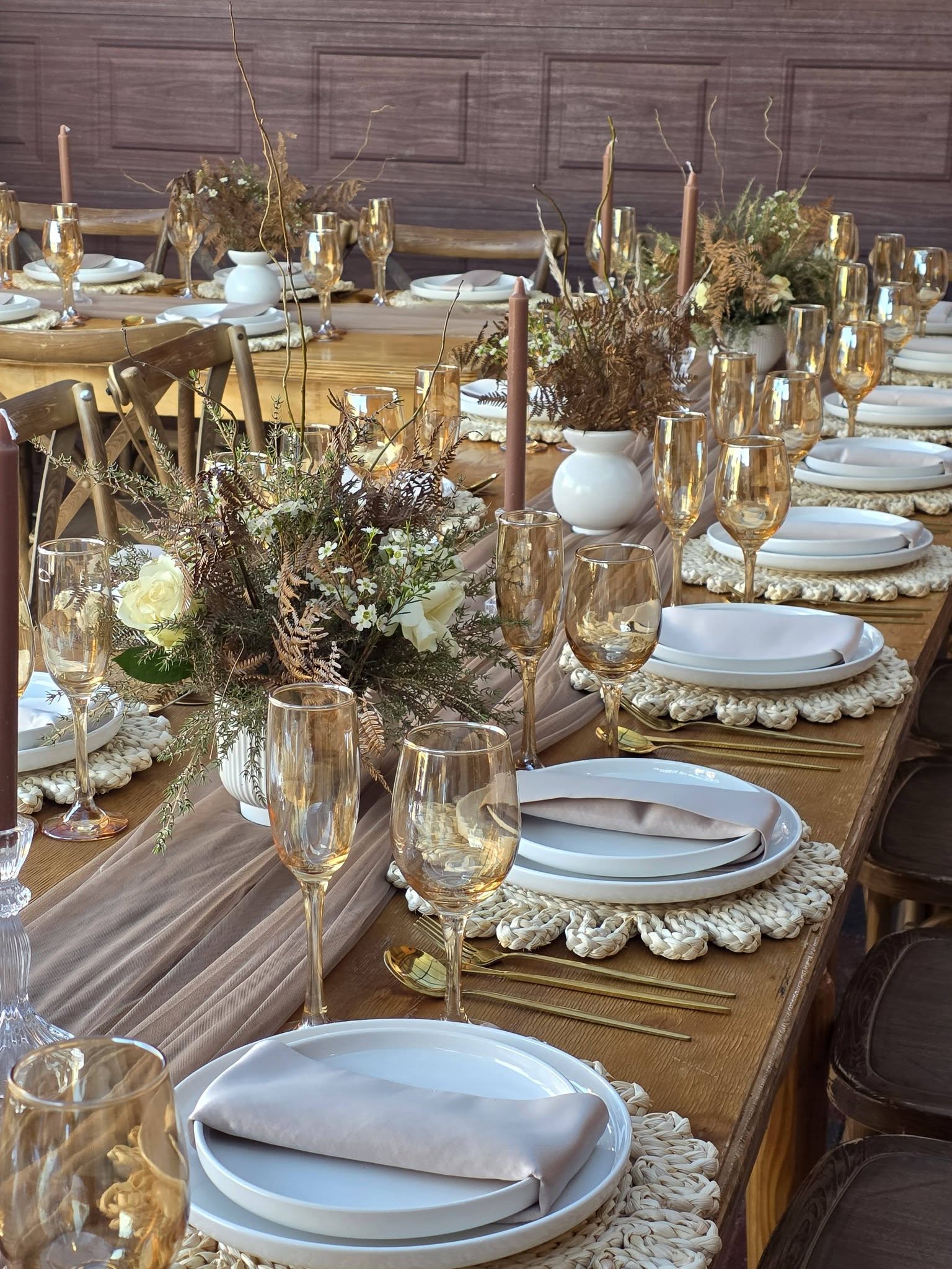 Lobola luncheon at Muano, rustic wooden tables with amber glassware, macramé placemats and dried botanical floral centrepieces